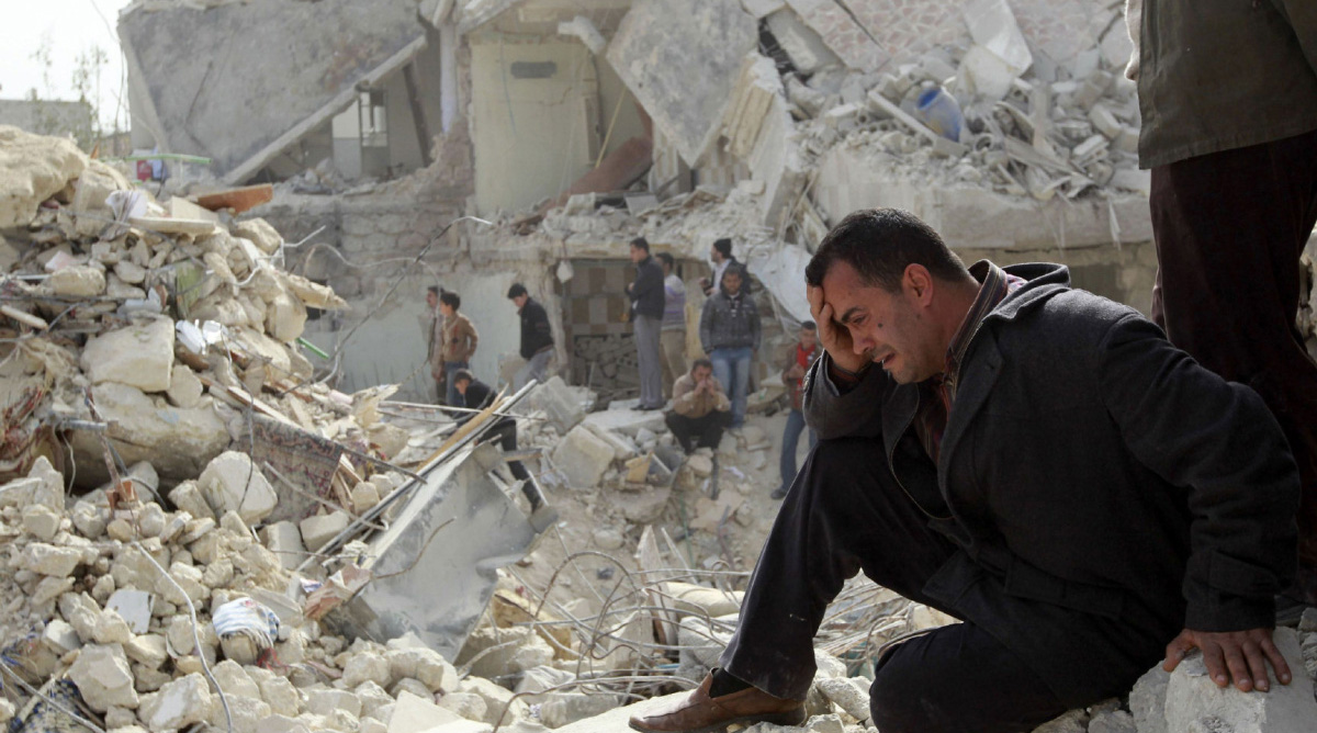 A man cries at a site hit on Friday by what activists said was a Scud missile in Aleppo's Ard al-Hamra neighbourhood