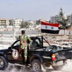 عناصر من _الدفاع الوطني_ التابع لقوات النظام السوري في إحدى المدن السورية